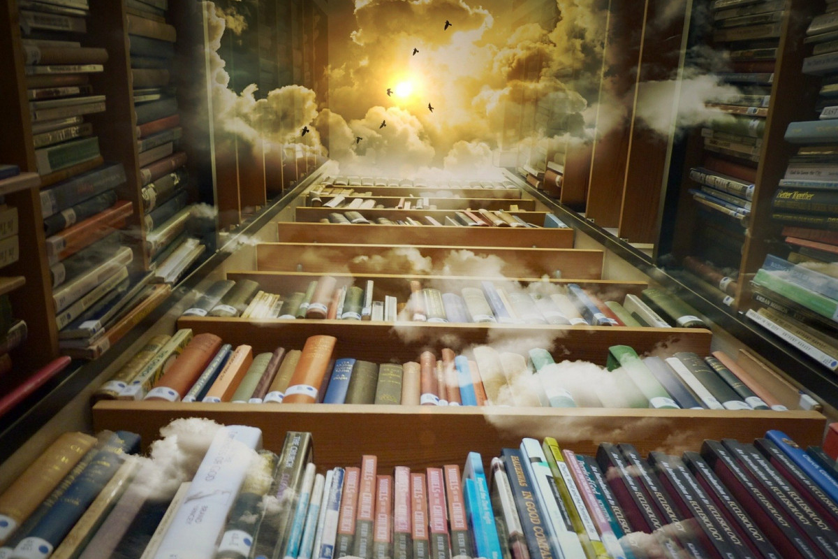 Looking up at bookshelves that fade into to clouds and sky