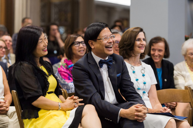 Evans Lam, laughing, sitting next to his wife, Susanna, and Dean Mary Ann Mavrinac