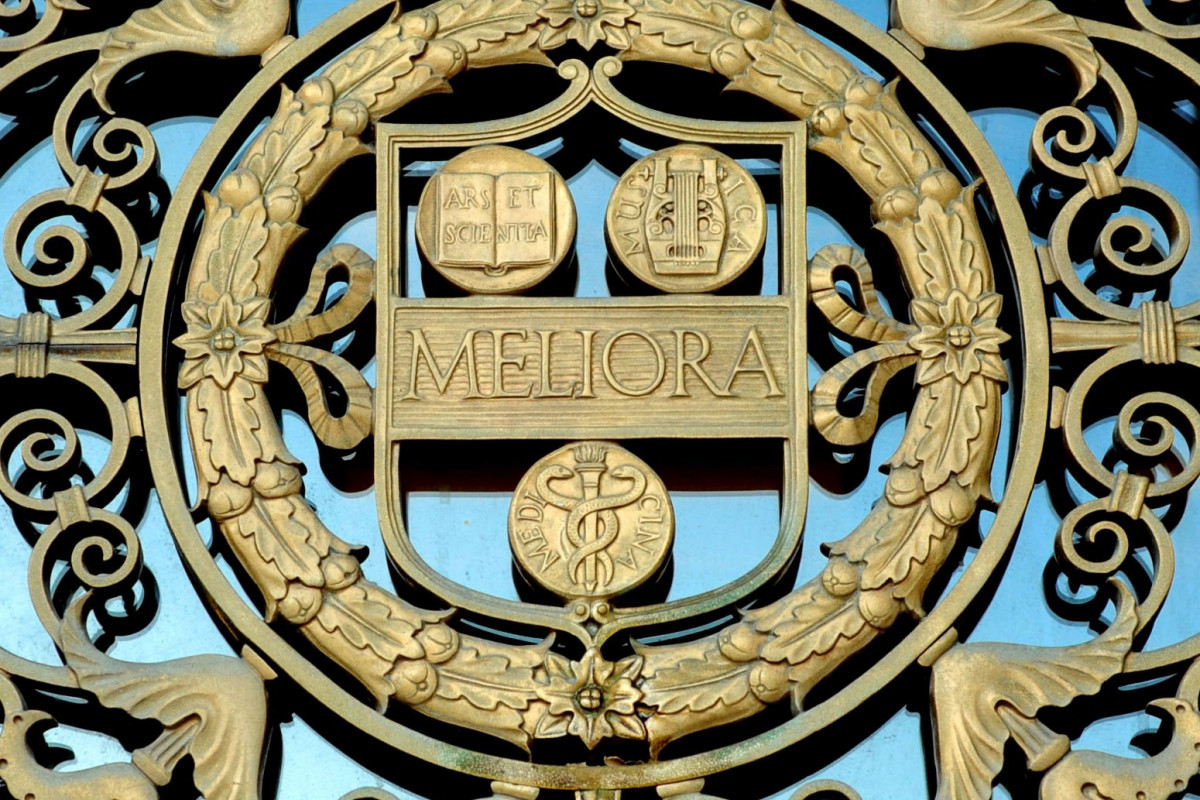 A gold representation of the University's shield from the entrance to Rush Rhees