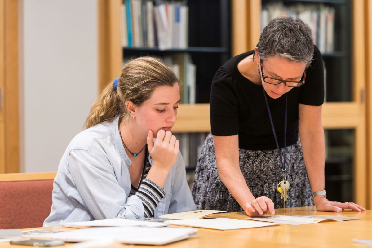 A librarian looking at materials with a student