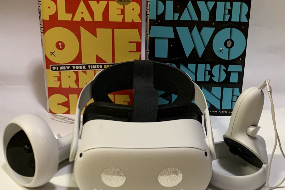 A VR headset positioned in front of the books "Ready Player One" and "Ready Player Two."