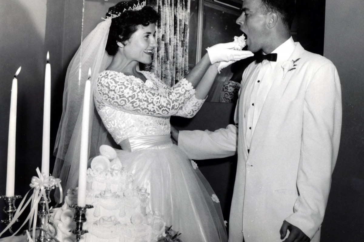 A young Louise Slaughter in her wedding dress feeding cake to her husband, Bob