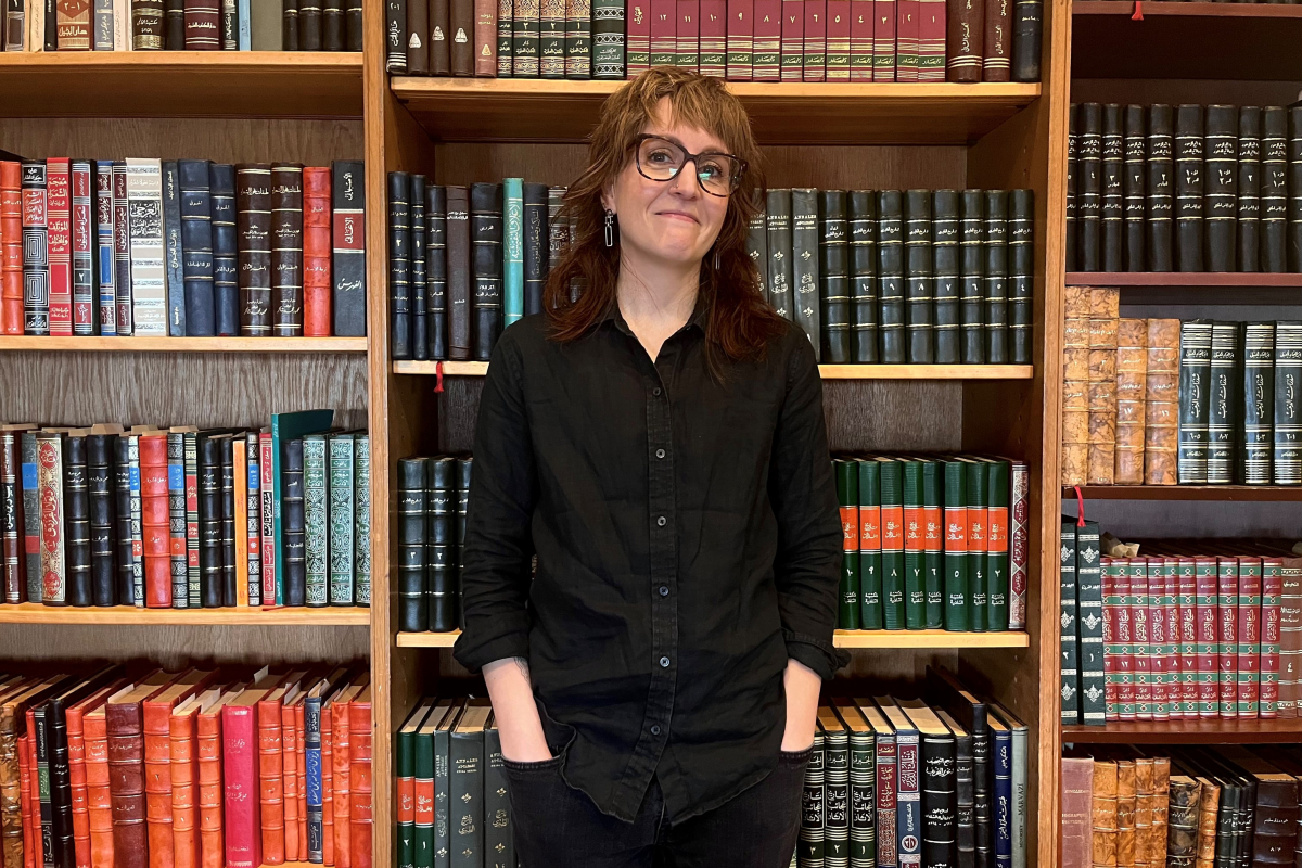 Anna Siebach-Larsen in front of a bookshelf in Robbins Library