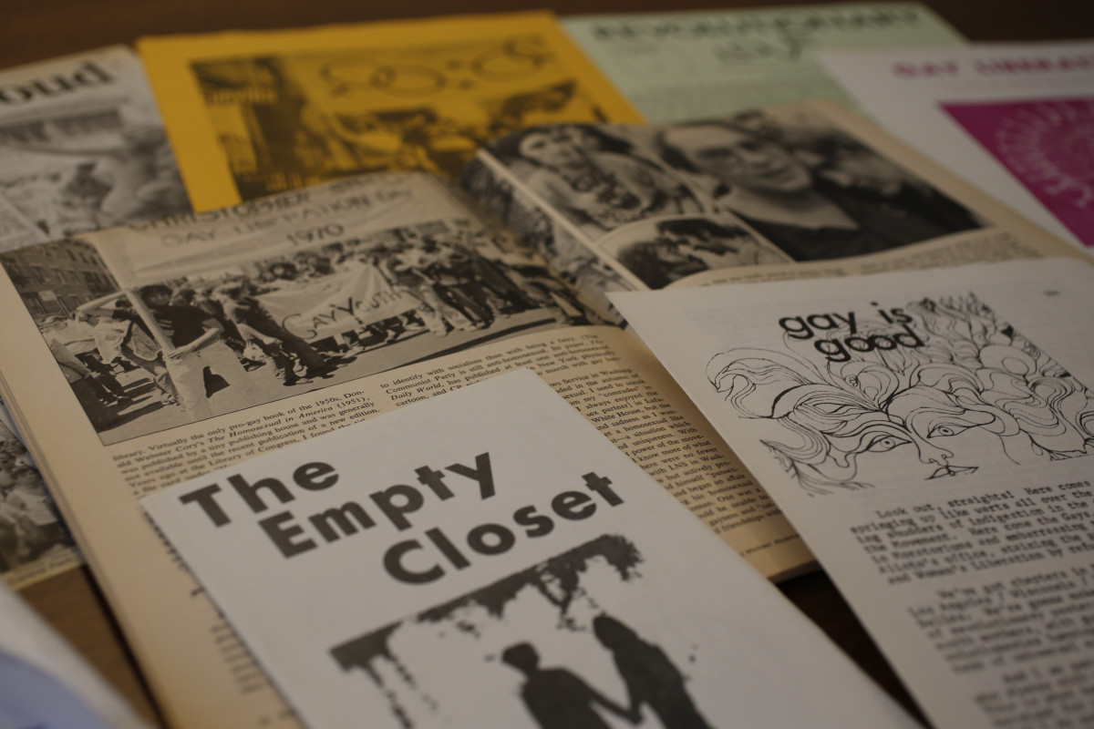 An assortment of old LGBTQ materials; "The Empty Closet" is prominently displayed