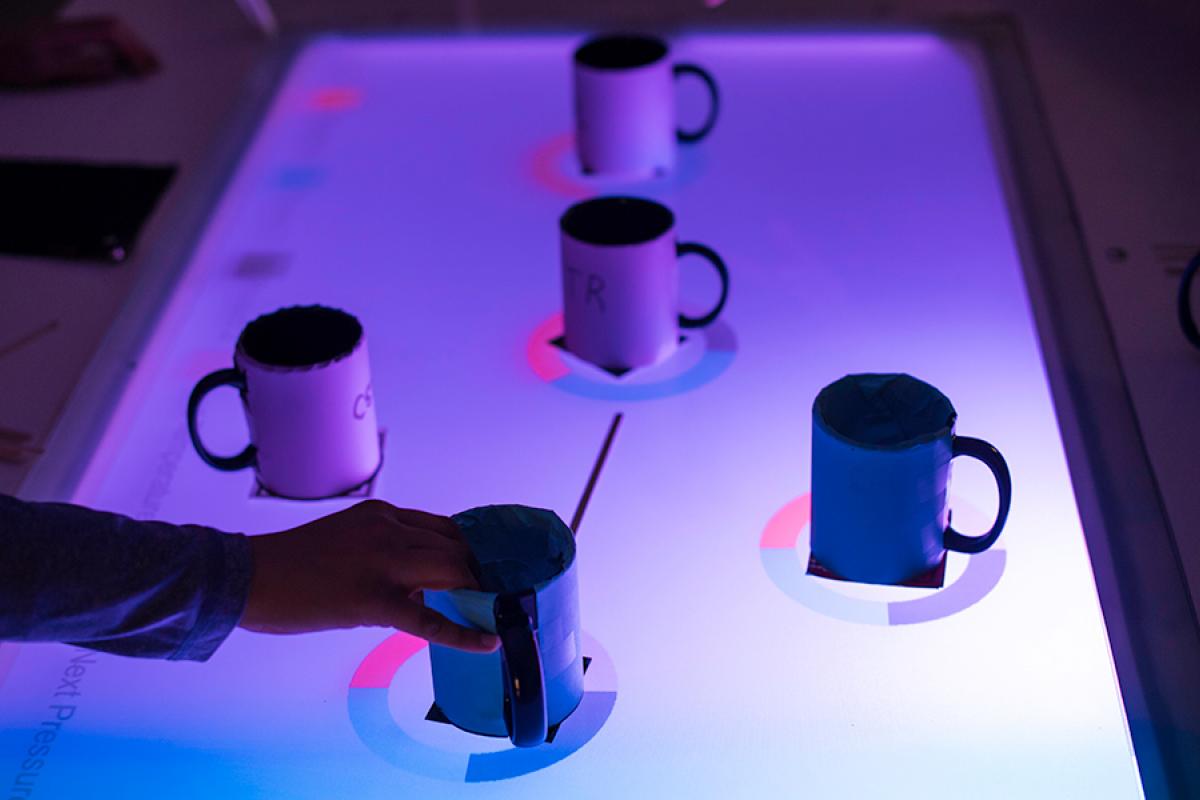 Coffee mugs on a glass table in Wegmans Hall are transformed into an AR classroom exercise that simulates a sprawling, real-life chemical plant.