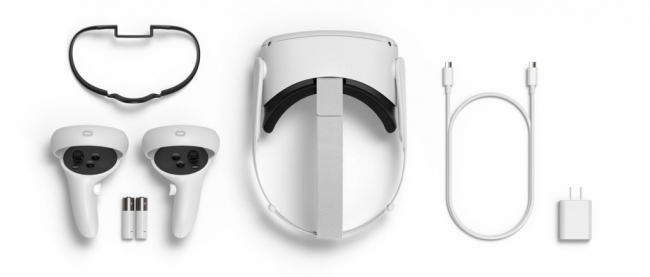 A white Meta Quest 2 headset with controllers and charging device