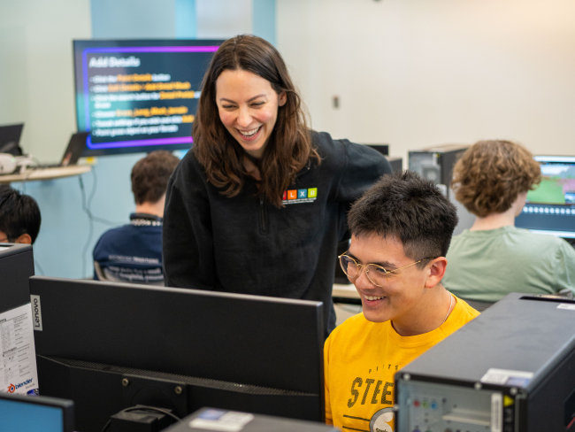 student and instructor laughing. 