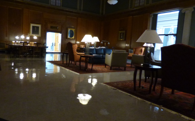 Rush Rhees Library's Great Hall, dark, empty, with gleaming floors