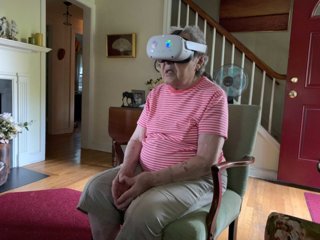 Ayiana's grandmother wearing a vr headset.