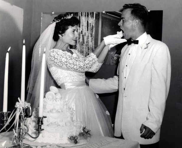 A young Louise Slaughter in her wedding dress feeding cake to her husband, Bob