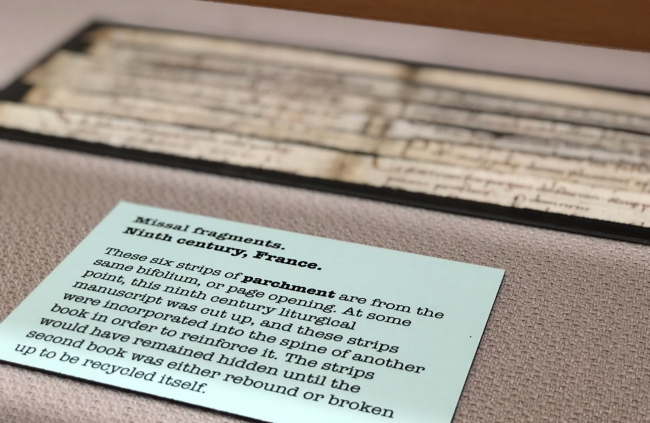 image of missal fragment and exhibit label in exhibit case