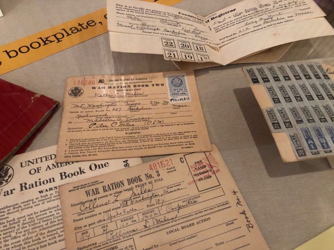 image of exhibit case containing World War II ration books and ration stamps 