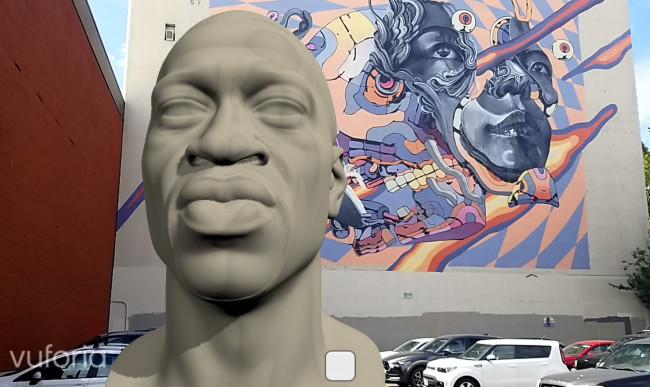 A virtual bust of George Floyd in front of a colorful mural in the Portland, Oregon