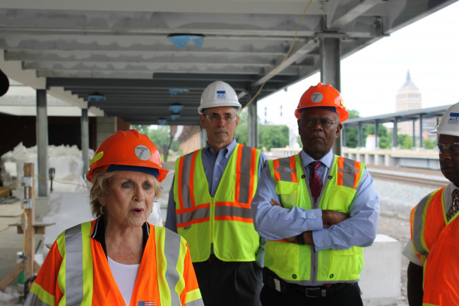 Louise Slaughter with Rochester Urban League President William Clark touring the site of the train station