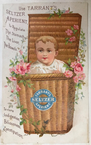 Trade card of baby in basket of flowers 