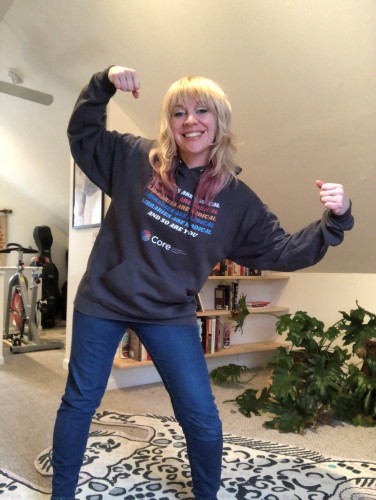 Lindsay Cronk, flexing and wearing a hoodie that says Libraries are radical. And so are you.