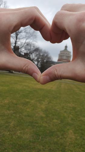 A hand in the shape of a heart around Rush Rhees Library