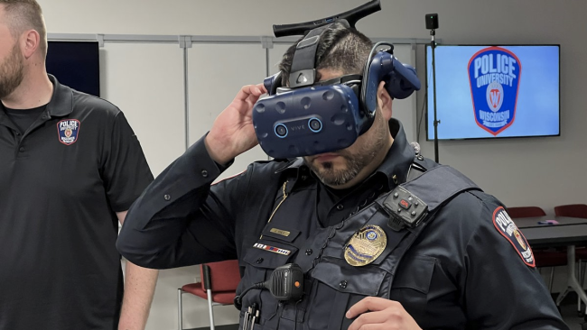 Lt. Juan Avila wearing a VR headset that the University of Wisconsin Police Department is using in de-escalation training. Tim Elliott.