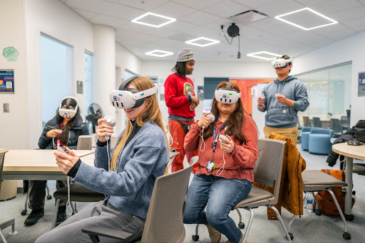 People in virtual reality headsets. 
