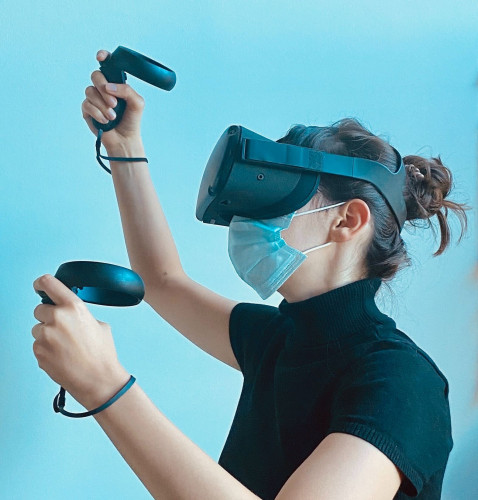 person in a VR headset wearing a mask