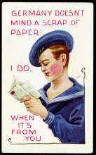 boy in sailor uniform holding card