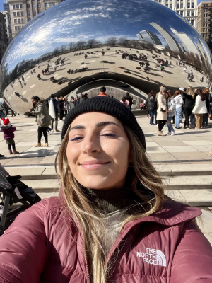 Rachel Smith taking a selfie in front of the Bean sculpture in Chicago, Illinois.